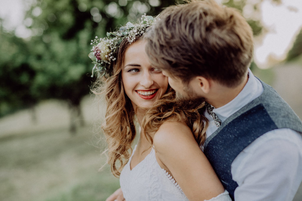 Beautiful bride and groom in green nature.