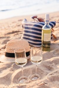 Glasses of the white wine on the sunset beach