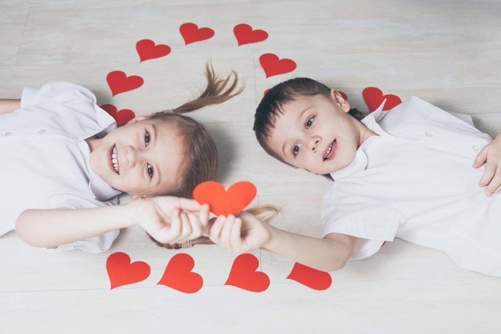 little boy and girl lying on the floor.