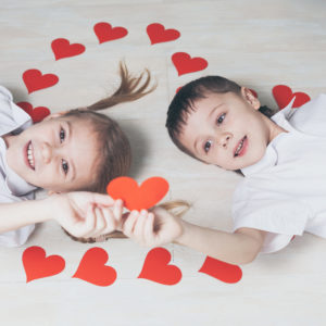 little boy and girl lying on the floor.