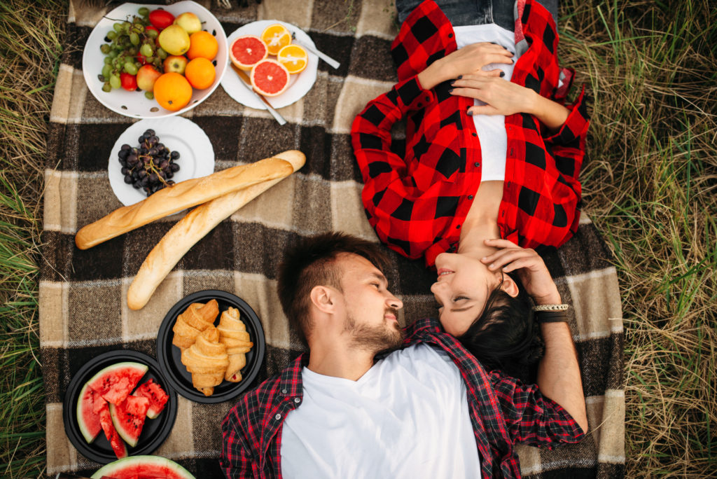 Love couple lies on plaid, top view