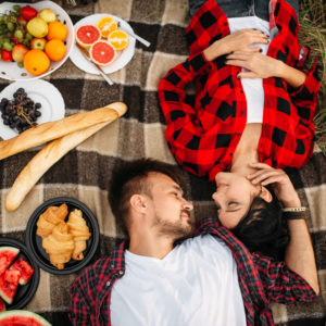 Love couple lies on plaid, top view