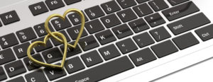Pair of golden wedding rings isolated on computer laptop keyboard