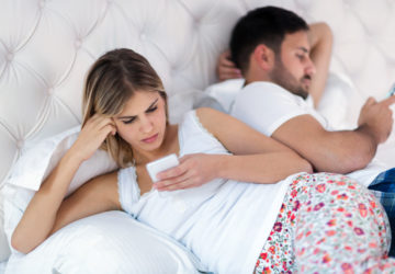 Picture of bored young couple in bedroom