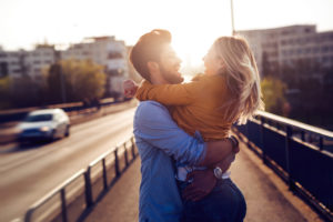 Portrait of loving couple dating at sunset in city