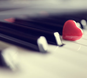 Red heart on piano keys