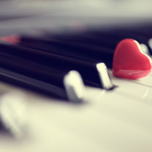 Red heart on piano keys