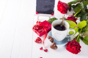 Red rose, coffee cup and gift box