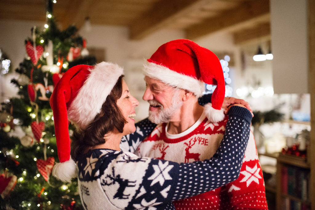 Senior couple with Santa hats at Christmas time.