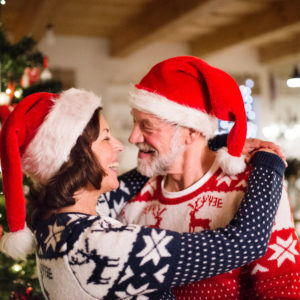 Senior couple with Santa hats at Christmas time.