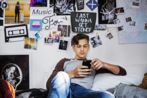 Teenage boy using smartphone