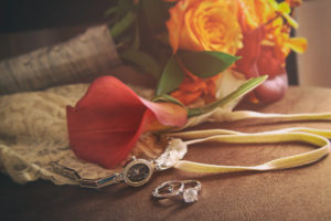 Wedding rings and accessories on chair