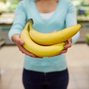 woman with bananas at grocery store