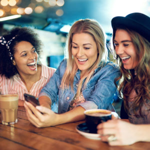 Women with with smartphone laughing