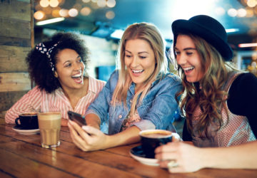Women with with smartphone laughing