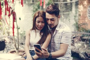 Young couple using a phone together